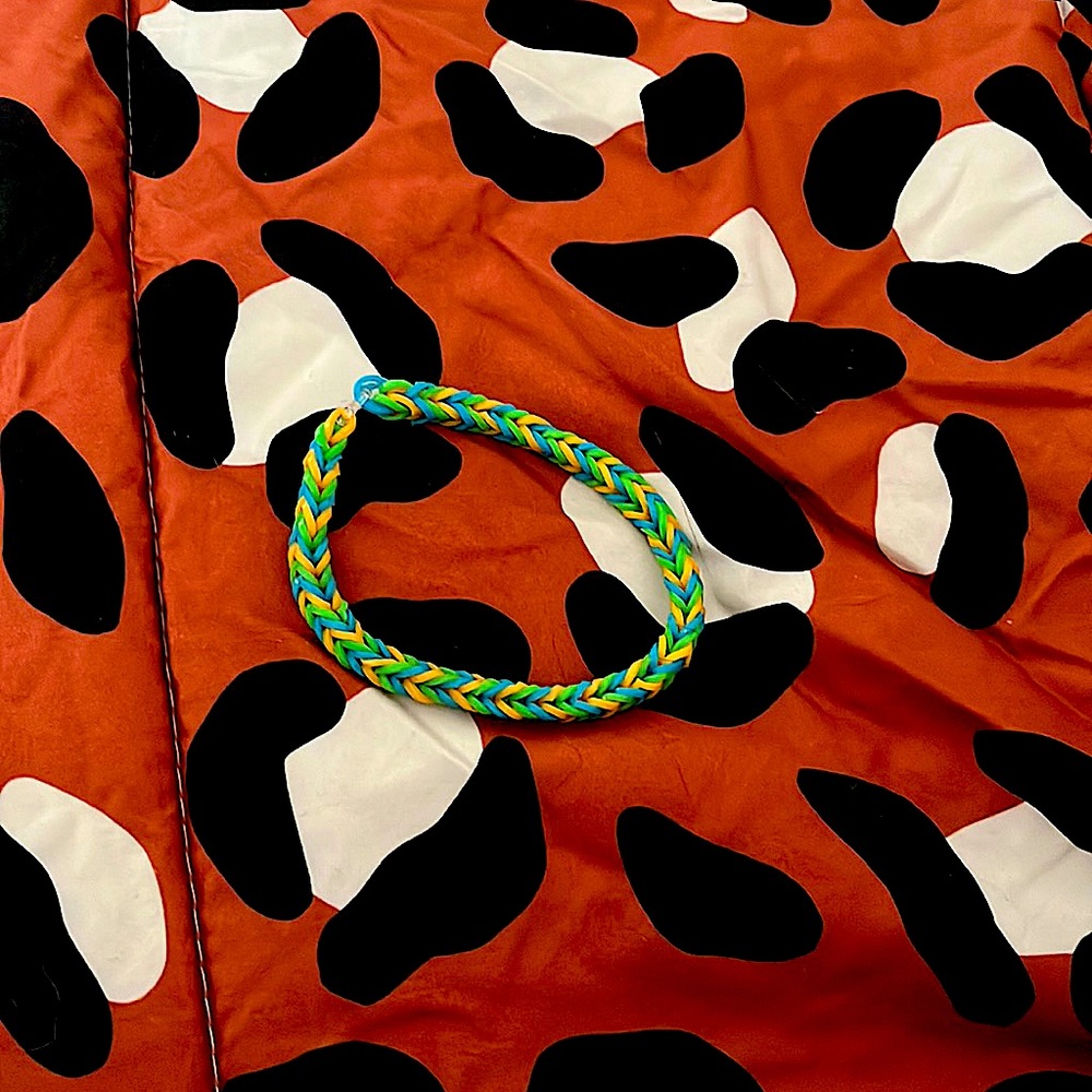 Rubber band bracelet colors are green orange and blue